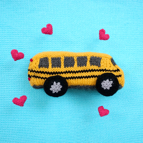 knit school bus with hearts around it.