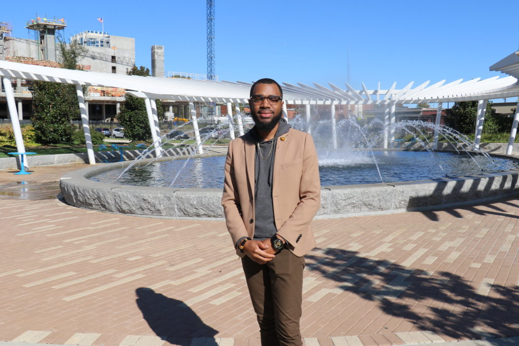 photo of bruce standing in front of a fountain.