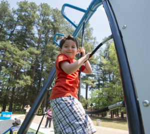 Youth playing on playground at Hornets Next Park