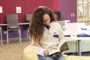 Young girl reading at a Charlotte Mecklenburg Library