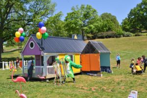 Wide shot of the tiny house with balloons