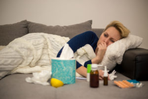 Woman laying on the couch with the flu