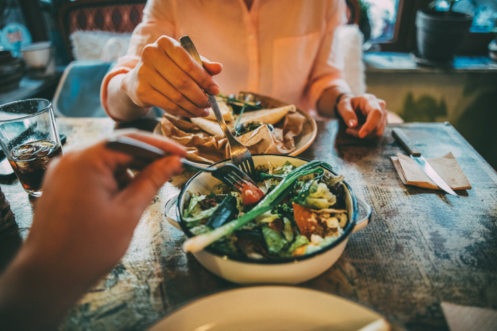 Two people sharing food during a holiday meal