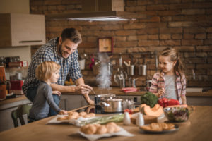 Family cooking food safely for the holidays