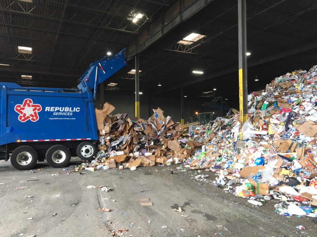 Recycling truck emptying recyclable materials.