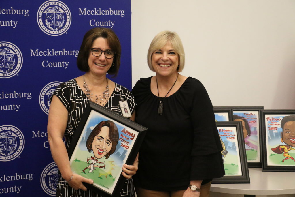 Ethics winner Amy Gilliam poses with County Manager Dena R. Diorio while accepting her Customer Service Hero Award.