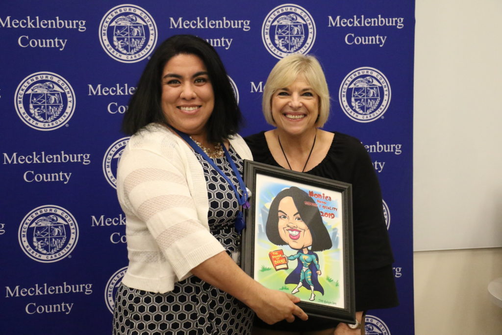 Service Quality winner Monica Madrigal poses with County Manager Dena R. Diorio while accepting her Customer Service Hero Award.