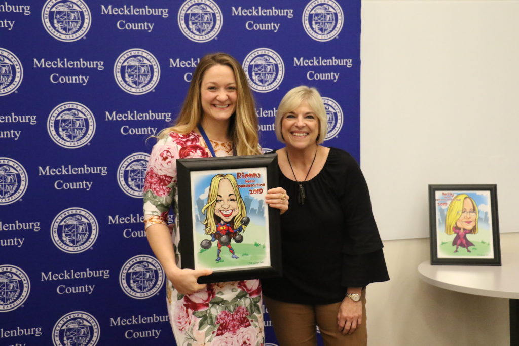 Communication winner Rienna Nuber poses with County Manager Dena R. Diorio while accepting her Customer Service Hero Award.