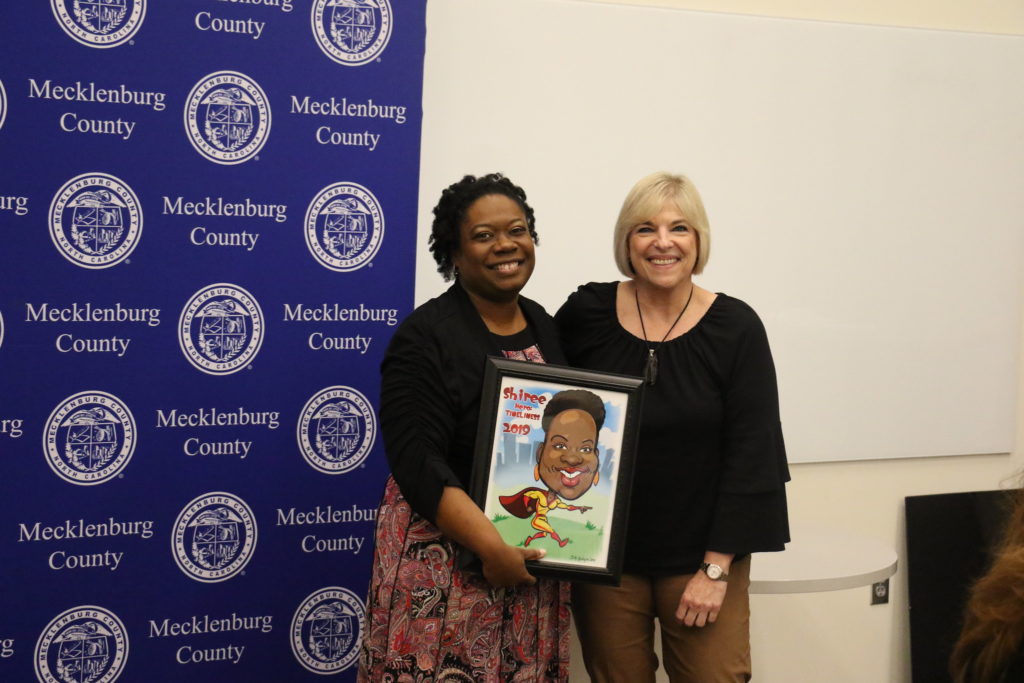 Timeliness winner Shiree Lewis poses with County Manager Dena R. Diorio while accepting her Customer Service Hero Award.