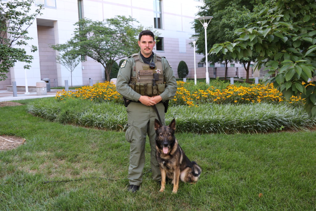 Mecklenburg County Sheriff's Deputy Elmendorf poses with his K-9 Nilz.