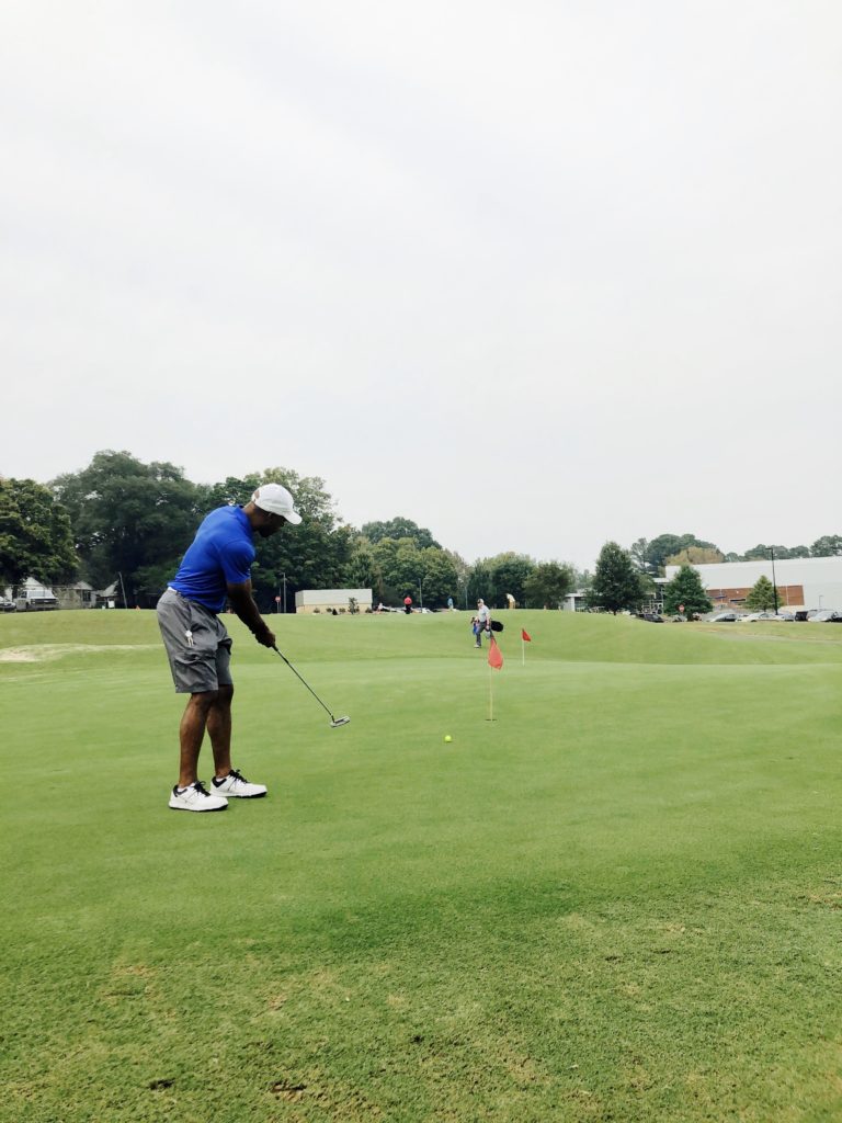 Man putting at public golf course