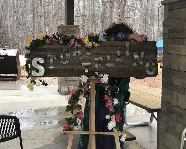 board decorated with flowers and greenery and the word "storytelling."