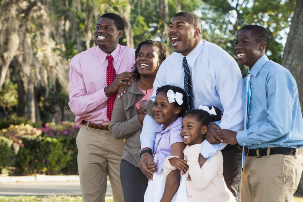 Portrait of African American couple with four children dressed up for Easter.