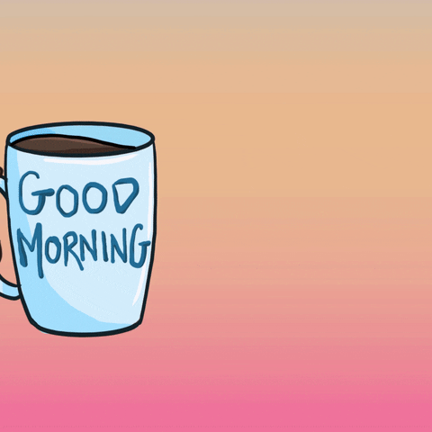 hand comes into the frame holding a mug of coffee with the words "good morning" on it.