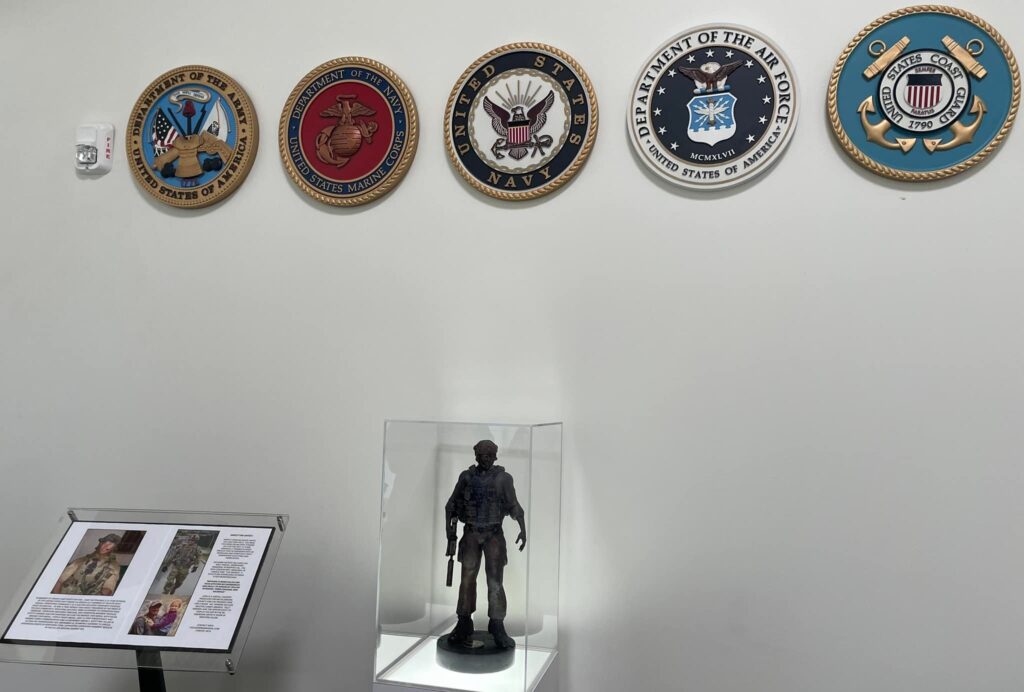 statuette of service member Scott Dayton in a glass case in Mecklenburg County's veteran service office