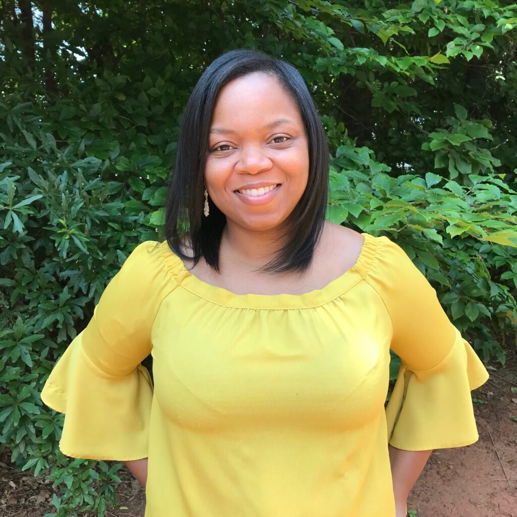 Monique Harris in a yellow blouse.