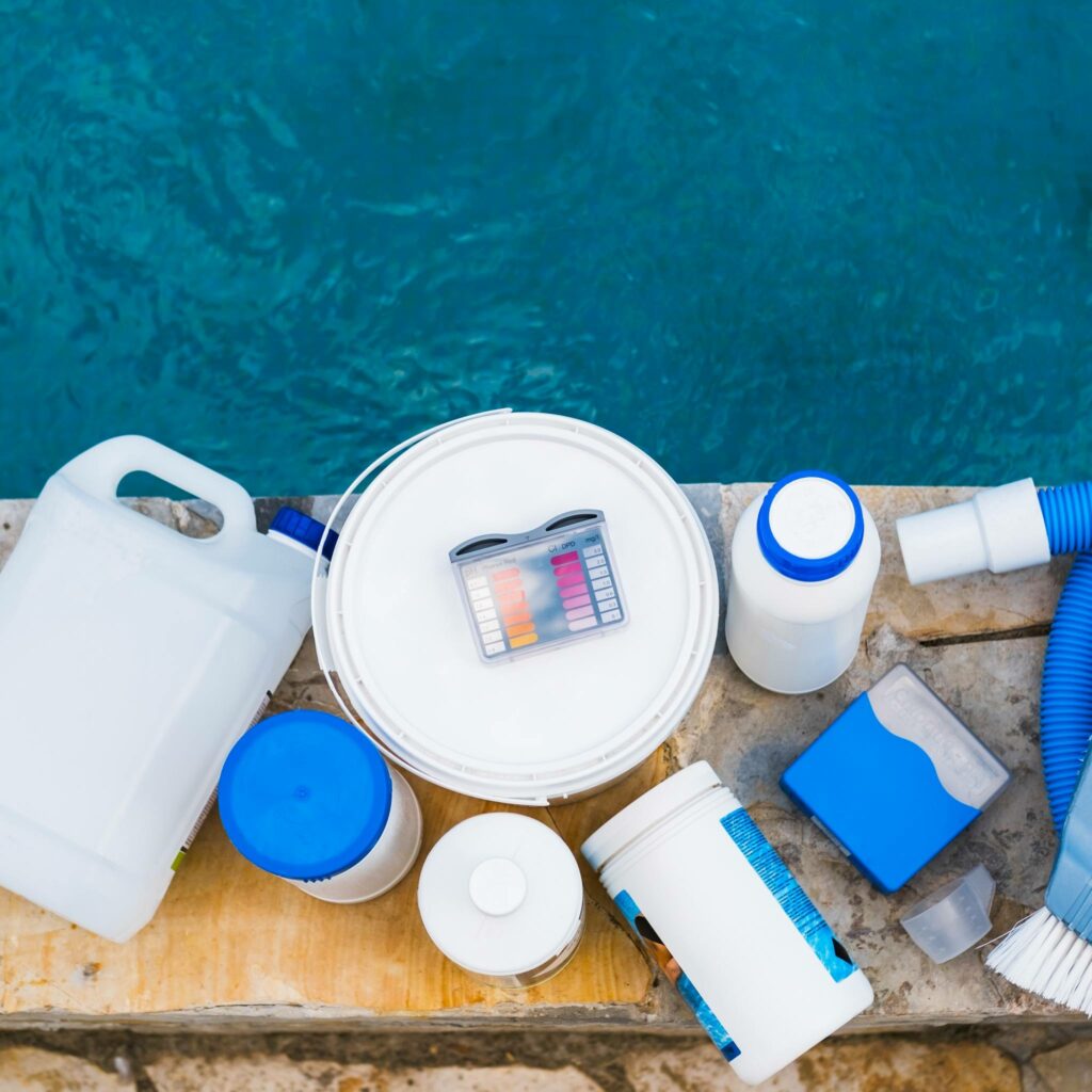 Pool chemicals on the edge of a pool.