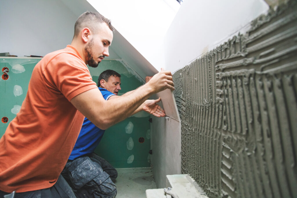 two professional tilers installing tiles