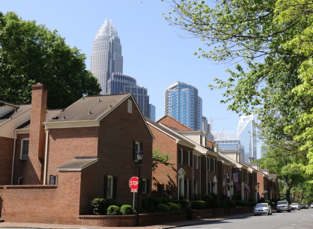View of brick townhomes with the Charlotte city skyline in the background